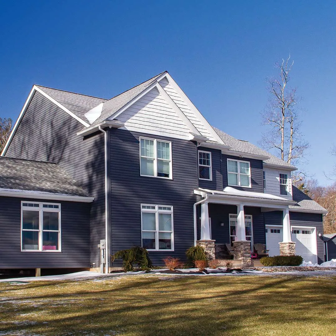 Construction team reviewing project plans on residential job site in Central Iowa